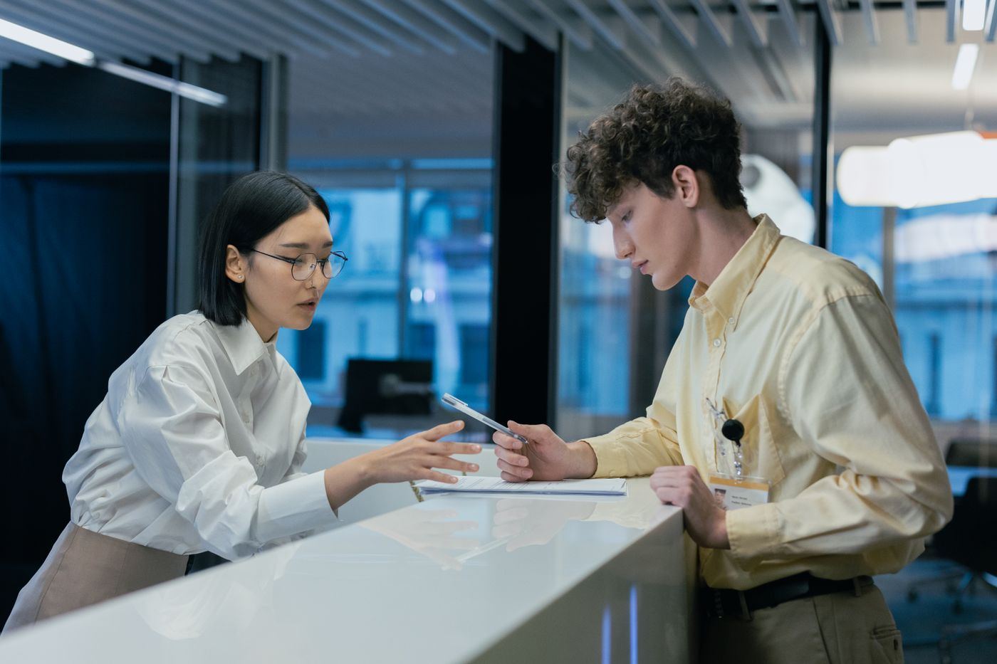 A customer service officer helping a visitor at the counter