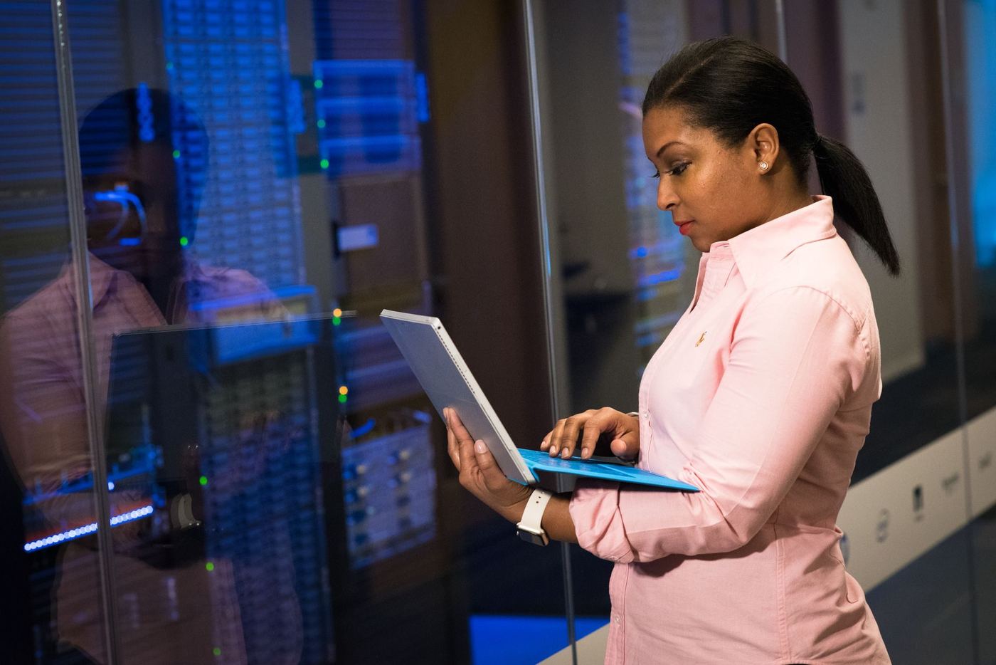 An engineer working on a laptop in a server room
