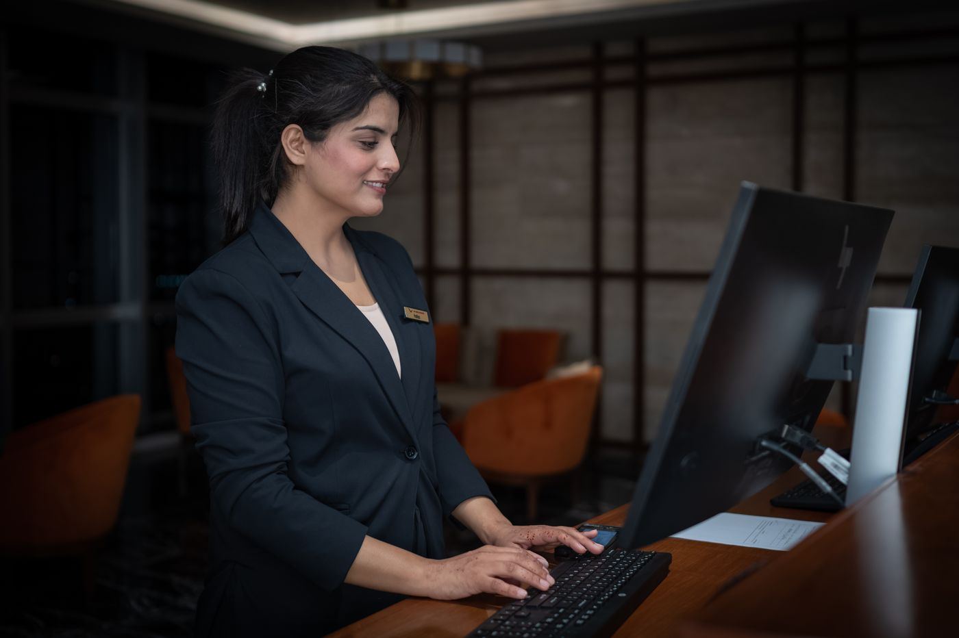 A front desk officer working at a computer
