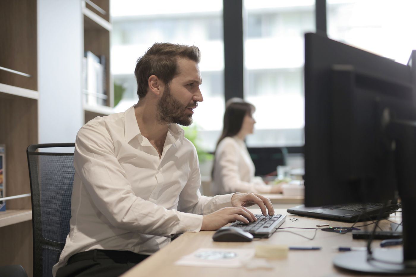 Colleagues working at their screens in a head office