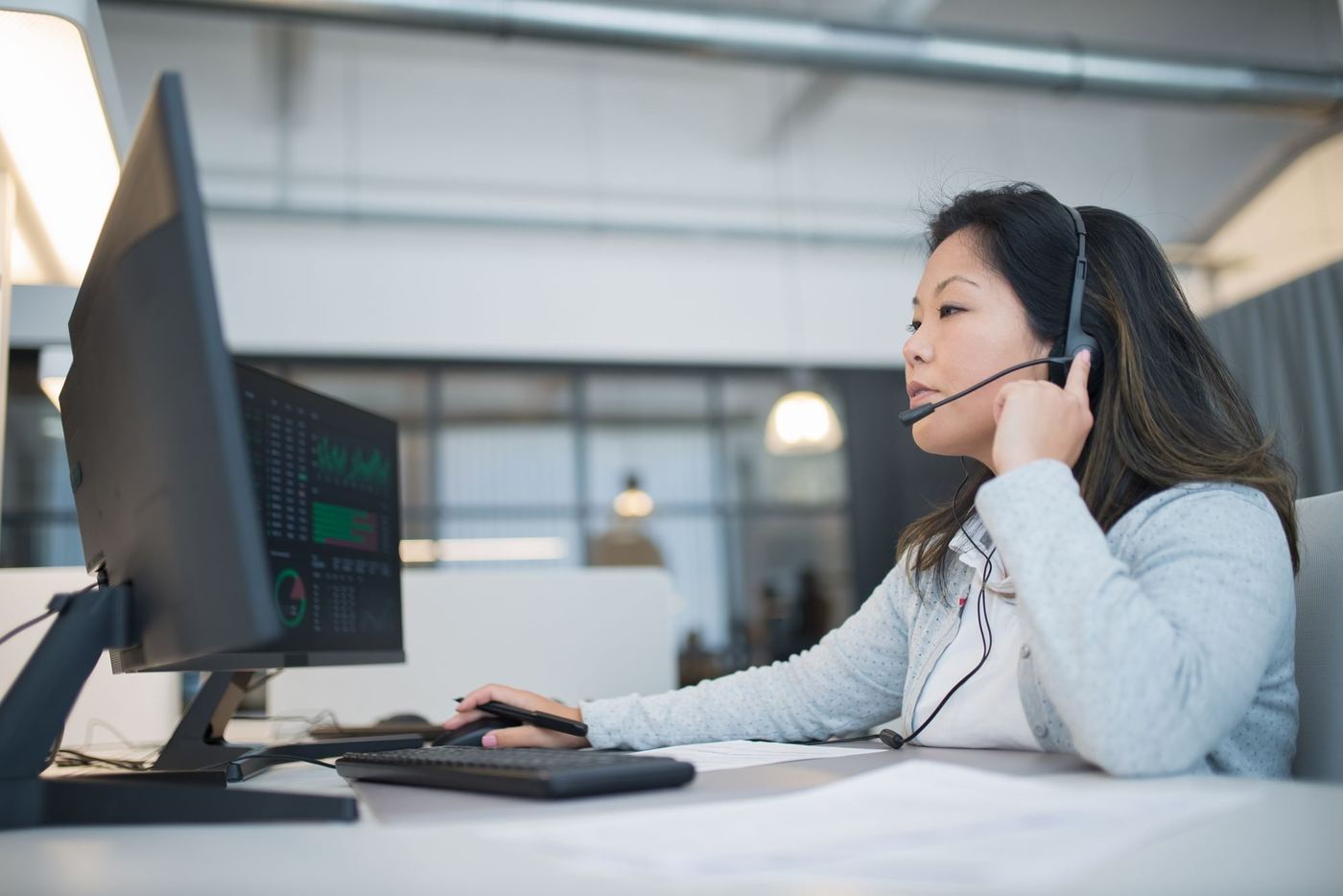 A member of the team on a call at a desk
