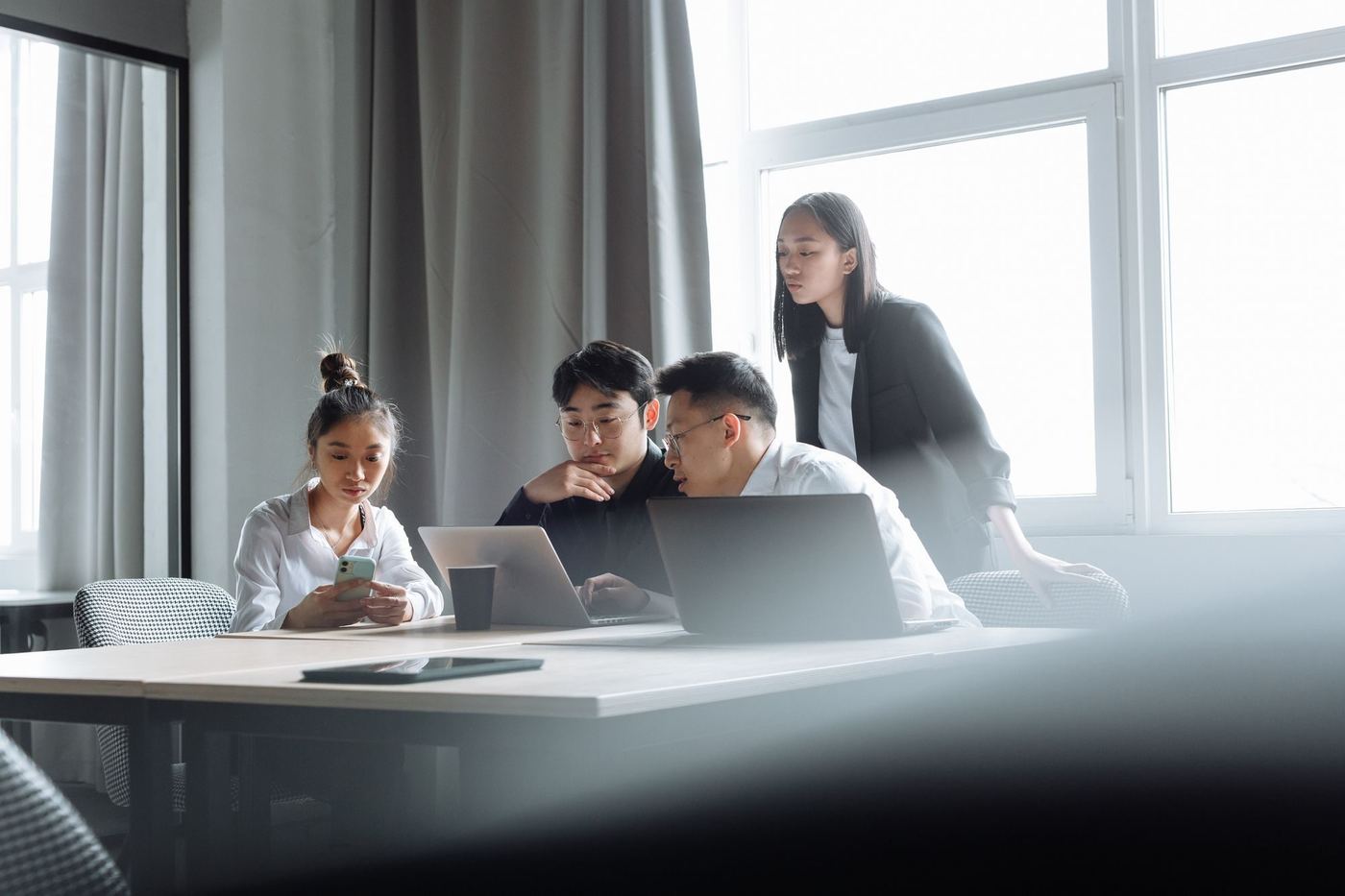 A team reviewing figures together on their laptops